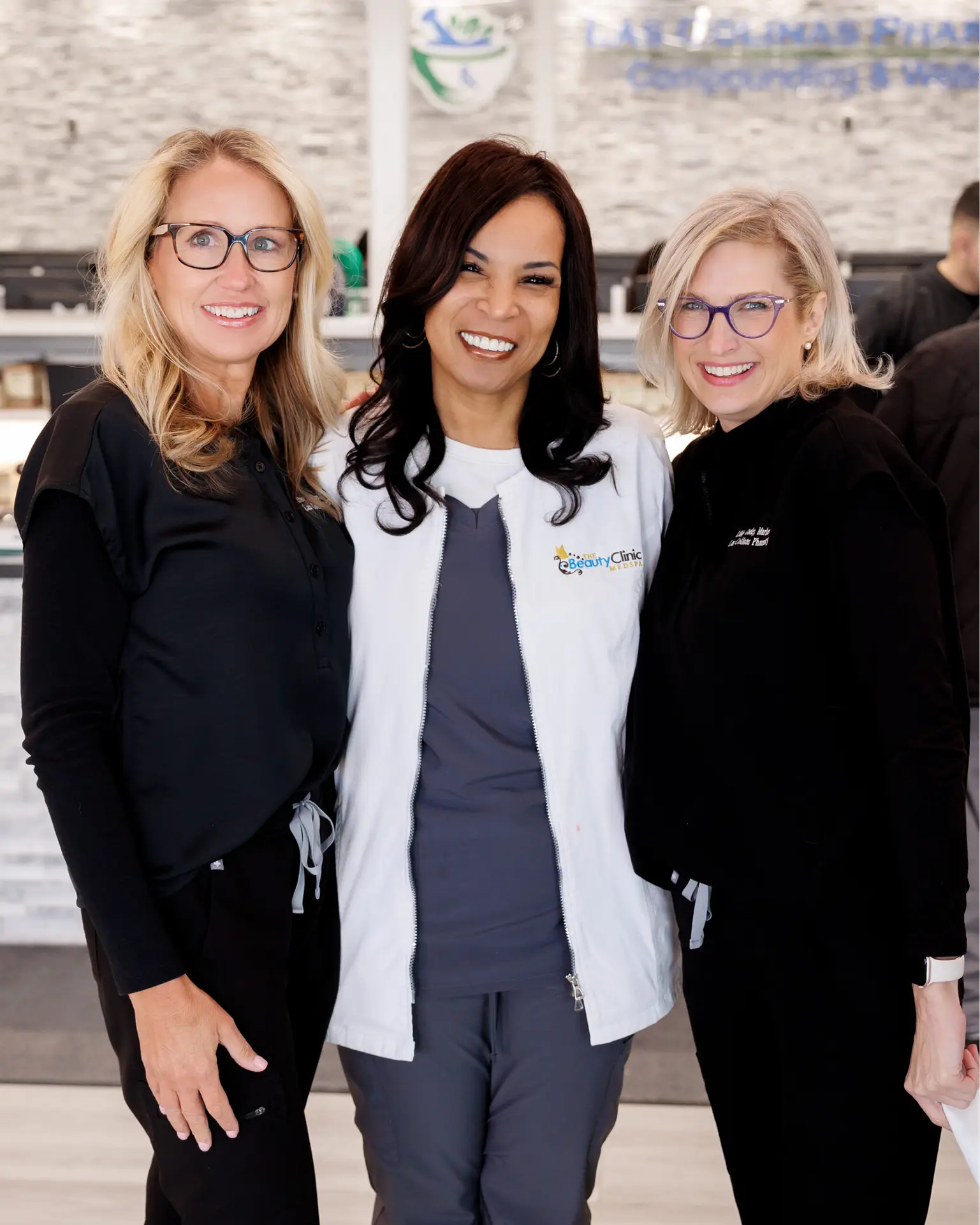 three persons standing in pharmacy