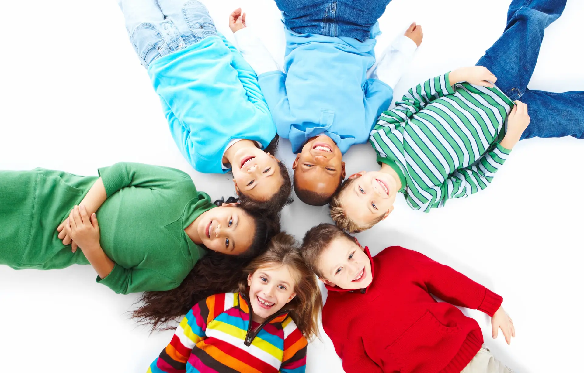 Six kids lying down in a circle over white background