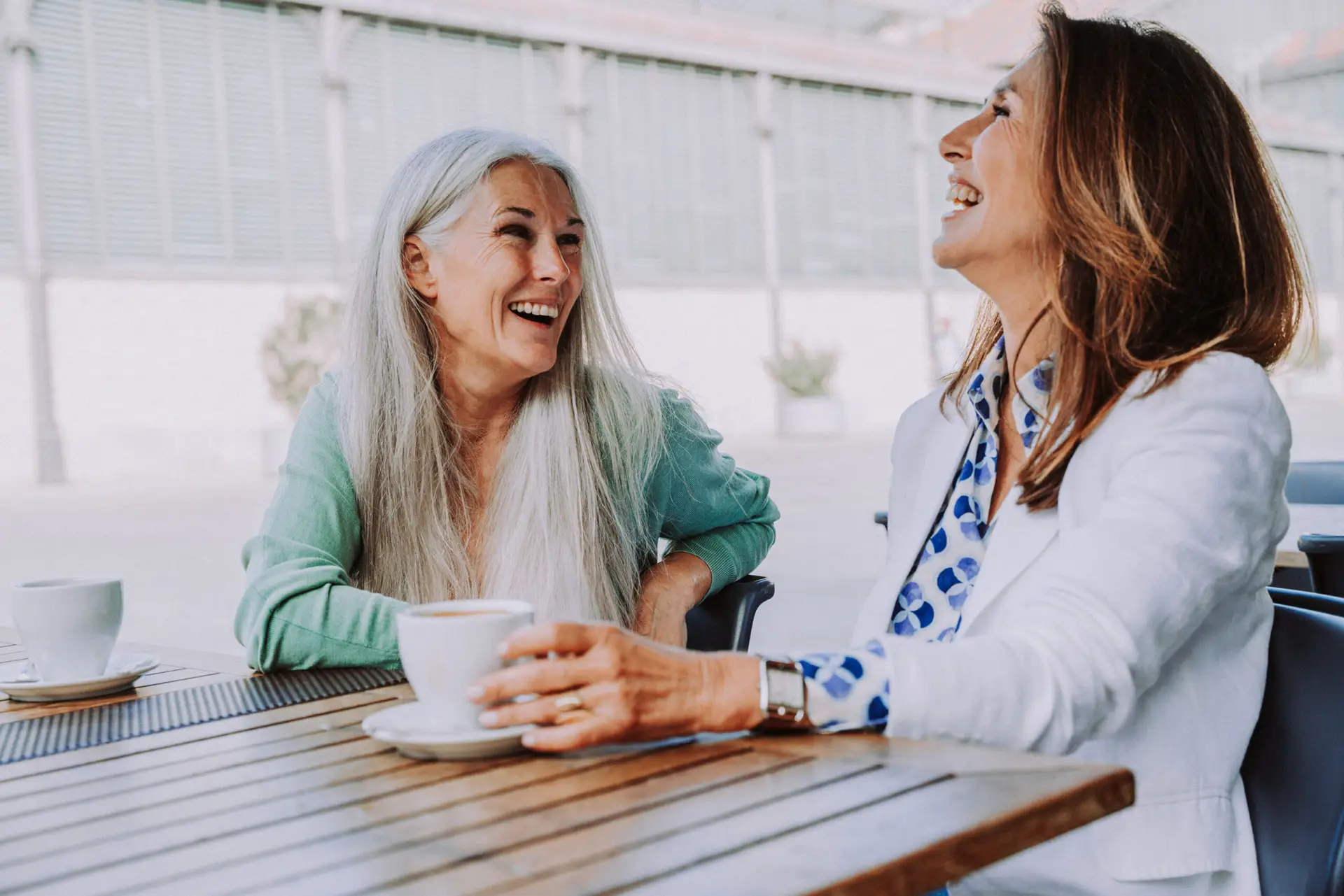 two people having a conversation over coffee